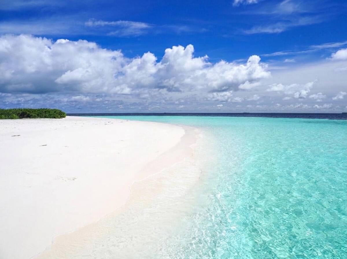 Turquoise lagoon and white sand beach at Coral Beach Maldives in Hangnaameedhoo